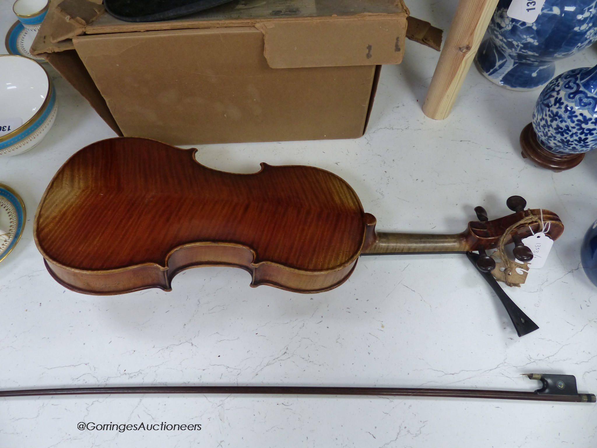 A Lowendall violin, labelled Stradivarius, 58cm long, together with a bow